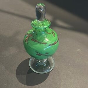 Green blown glass decorative vessel with glass stopper.